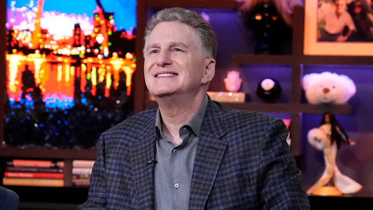 Michael Rapaport wearing a suit and looking forward
