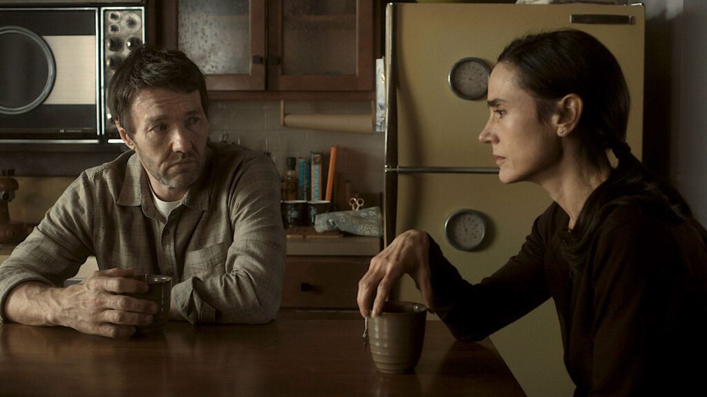 a husband and wife sit at a kitchen table