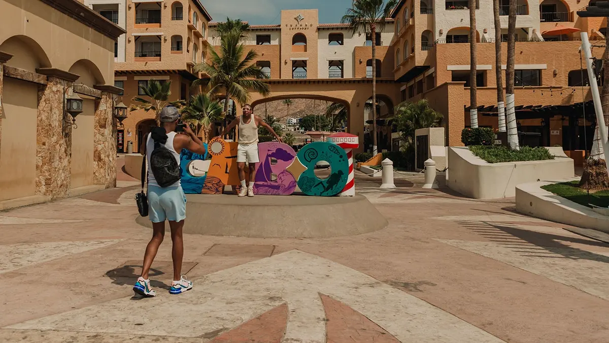 Tourists photograph in downtown Cabo San Lucas, Mexico.