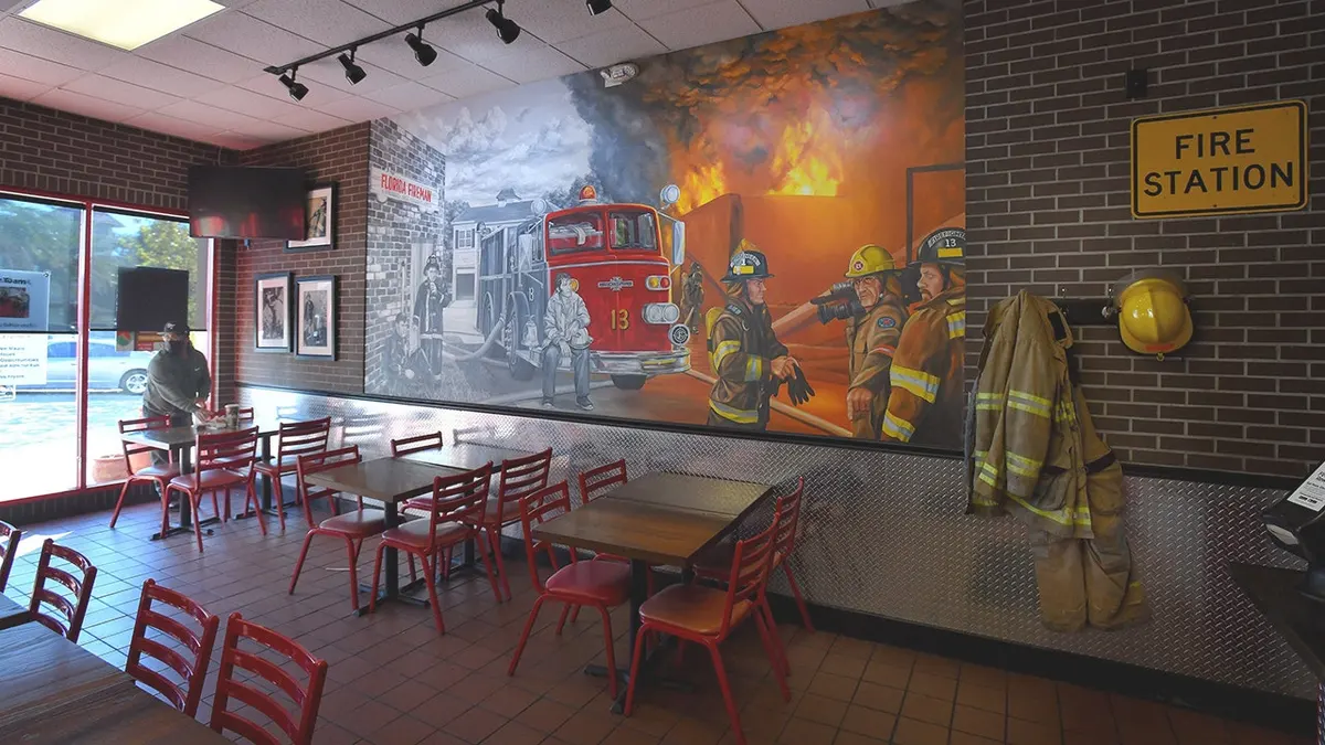 A mural in a restaurant depicts firefighters