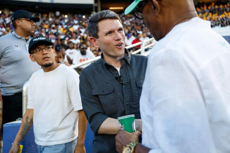 two men standing on the field in a football stadium
