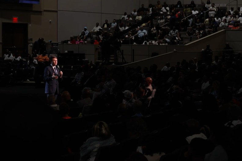 a man addressing an auditorium full of people