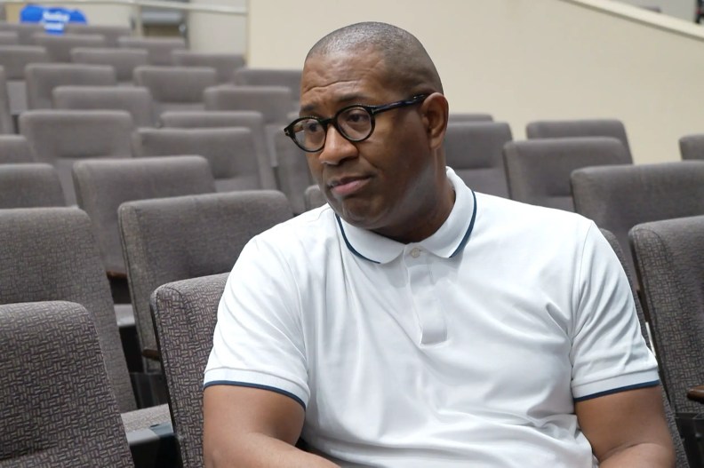 a man sits in an empty auditorium
